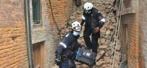 Rescuers holding rescue radar case after earth quake