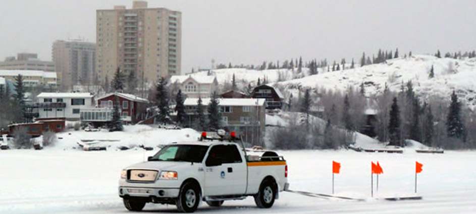 Snow scenery with a truck and buildings