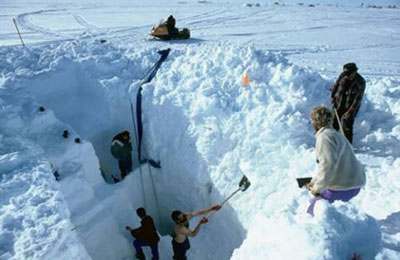 Excavación manual de nieve en la superficie para establecer el inicio del pozo de excavación.